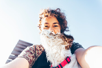 Mid adult woman taking selfie with dog