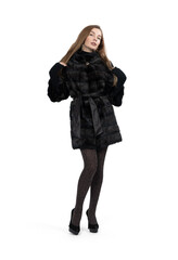 Fototapeta premium Young pretty girl posing in dark short mink fur coat, full height isolated on white background 
