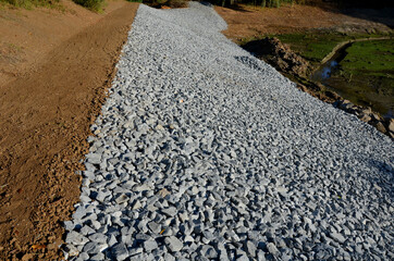 The mud at the bottom of the pond is green with algae that have overgrown fertilized alluvial sediments. during the reclamation, the excavator created a new one from the stream bed. excavation, dig