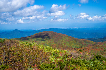 宮城県栗原市、秋田県湯沢市、雄勝郡東成瀬村、岩手県一関市にある栗駒山を紅葉の時期に登山する風景A view of climbing Mt. Kurikoma in Kurihara City, Miyagi Prefecture, Yuzawa City, Akita Prefecture, during the autumn foliage season.