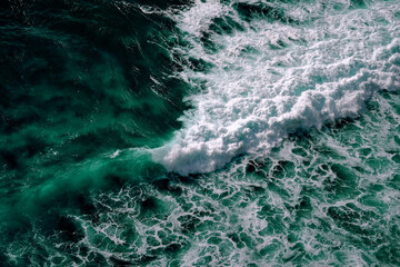 Aerial view to seething waves with foam. Waves of the sea meet each other during high tide and low tide - 460999620