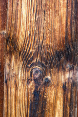 Drewniane tło z brązowych desek z widocznymi sękami