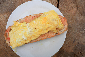 french omelette over tomato bread