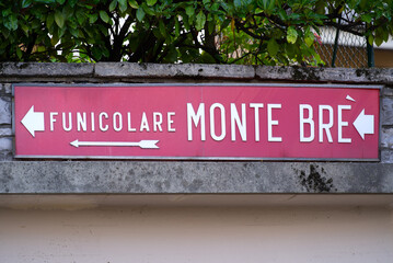 Sign with arrow to Substantive
funicular to Mountain Monte Brè at City of Lugano on a late summer morning. Photo taken September 11th, 2021, Lugano, Switzerland.