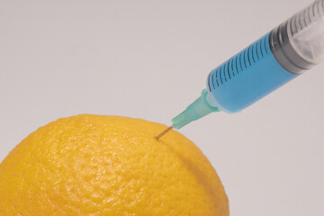 Poisoned foods. Poisoned lemon. Poisonous substance in a syringe. Blue liquid injection. Yellow...