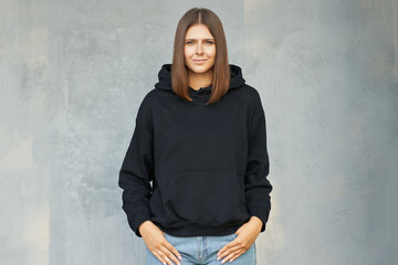 Young woman in black hoodie.