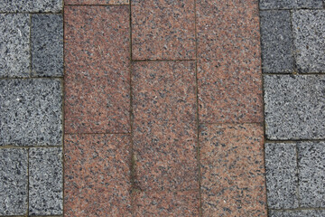 Brown-gray granite pavement. Pavement texture background. 