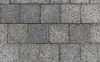 Gray granite pavement. Pavement texture background. 