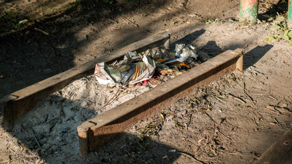barbecue area in the forest with garbage