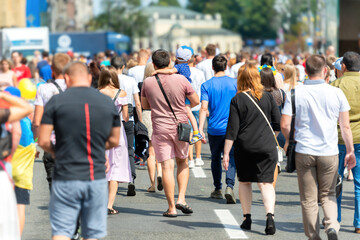 Crowd of people with men and women on busy city street