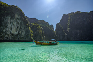 The scenery of a lone long boat and rocks on Pileh Lagoon in Krabi, Thailand