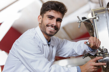 portrait of young man operating machinery