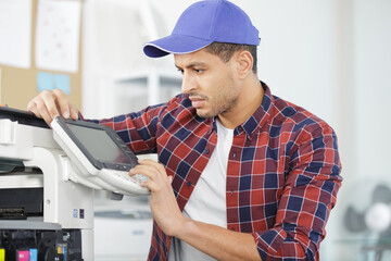 hardware repairman repairing broken printer fax machine