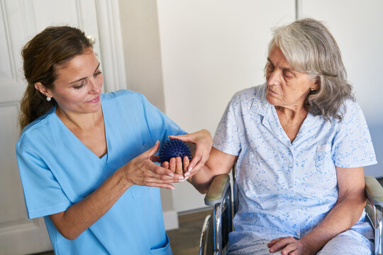 Elderly Woman In A Wheelchair During Physiotherapy After A Stroke