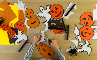 DIY crafts for Halloween. Decorations for the Halloween holiday made with your own hands. background for the Halloween holiday.  paper crafts, pumpkins, ghosts, bats, spiders.