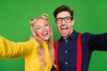Photo of young couple have fun grimace fooling discotheque make selfie 50s isolated over green...
