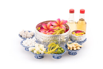 Jasmine garland and Colorful flower in water bowls decorating and scented water, perfume, marly limestone, pipe gun isolated on background for songkran festival or thai new year.