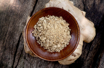 Fresh ginger rhizome and dried powder on nature background.