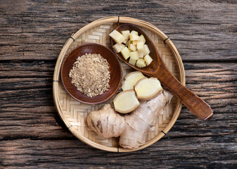 Fresh ginger rhizome and dried powder on nature background.