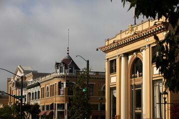 During a break in the fog, afternoon sunlight shines on the historic city center of downtown Salinas, California, USA. - obrazy, fototapety, plakaty