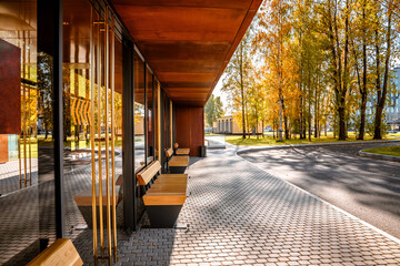 Stylish bus stop with wooden benches, modern architecture for the city
