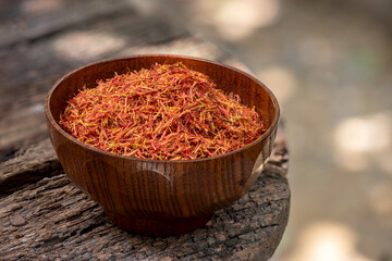 Dried safflower, petals on nature background.