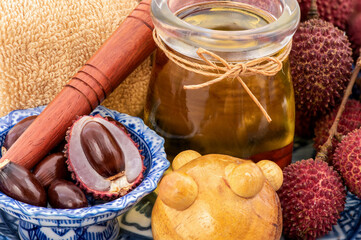 Lychee or Litchi chinensis,fruits and oil massage from seed  isolated on white background.