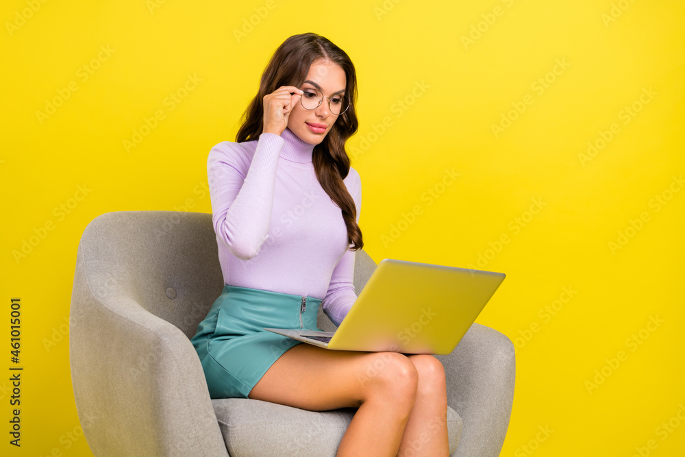 Sticker Photo of calm focused pretty person hand touch eyewear use netbook isolated on bright yellow color background