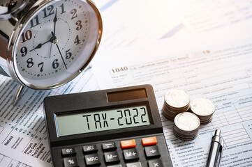 Tax word and 2021 number displayed on a calculator. Business and tax concept. Pay tax in 2022...