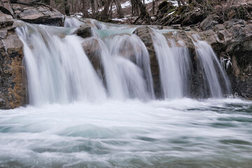 View of waterfall on Zhane river on cloudy winter day. Krasnodar Krai, Caucasus, Russia.