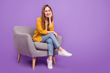 Obraz na płótnie Canvas Full length photo of attractive lady sit armchair tv-show wear casual outfit isolated over purple color background