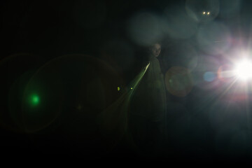Girl posing in green draping on dark background