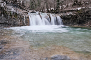 View of waterfall on Zhane river on cloudy winter day. Krasnodar Krai, Caucasus, Russia.