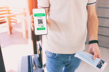 The man showing digital health passport app in mobile phone for travel.
