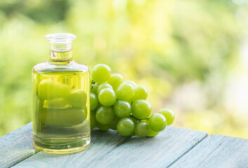 Grape fruits and oil isolated on nature background.