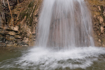 Fototapeta premium View of Gebiusskiy waterfall in Teshebs river gorge on winter day. Krasnodar Krai, Caucasus, Russia.