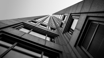 Obraz premium abstract view of Modern building in the city. Perspective Look up view with sunlight. Architecture, construction, investment, finance. Urban geometry