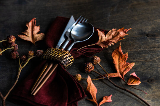 Autumnal rustic table setting with fall foliage decorations