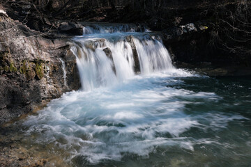 Waterfall on Zhane river on sunny winter day. Krasnodar Krai, Caucasus, Russia.