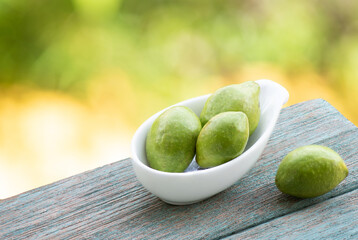 Terminalia chebula or chebulic myrobalans, fruits on nature background.