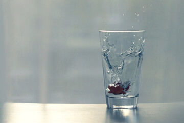 A glass of drinking water with splattered water