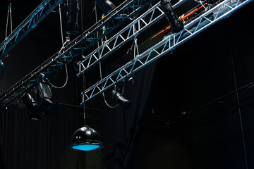 photo from below of metal stage with theater lights