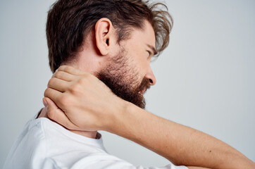 Fototapeta premium bearded man in a white t-shirt stress medicine pain in the neck light background
