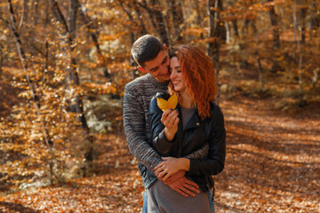 A young couple in love in the autumn forest