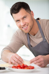 adult man cutting cherry tomatoes