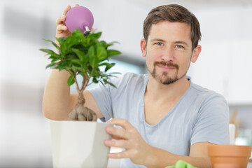 man is taking care of his bonsai