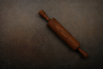 Vintage wooden rolling pin for dough on table