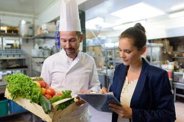 manager and chef holding vegetables