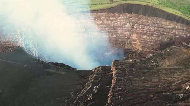Cinemaic Aerial shot over a volcano crater full of  steam of Erupting Volcano in Central America. Masaya, the &ldquo;Mouth of Hell&rdquo;, Nicaragua. Close up footage