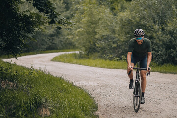 Fototapeta na wymiar Sporty man in helmet riding bicycle on fresh air
